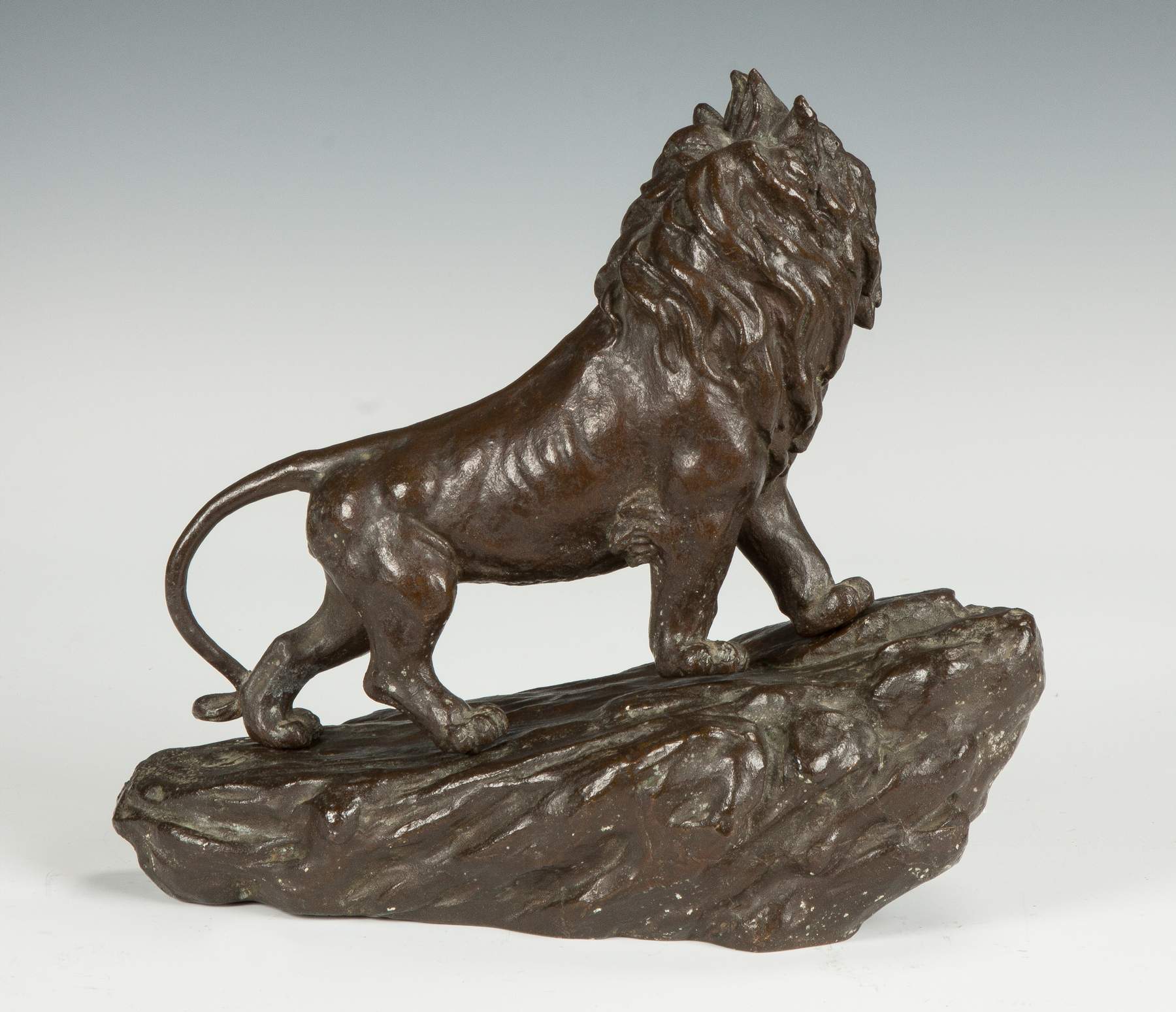 Bronze Sculpture of a Lion on a Mountain