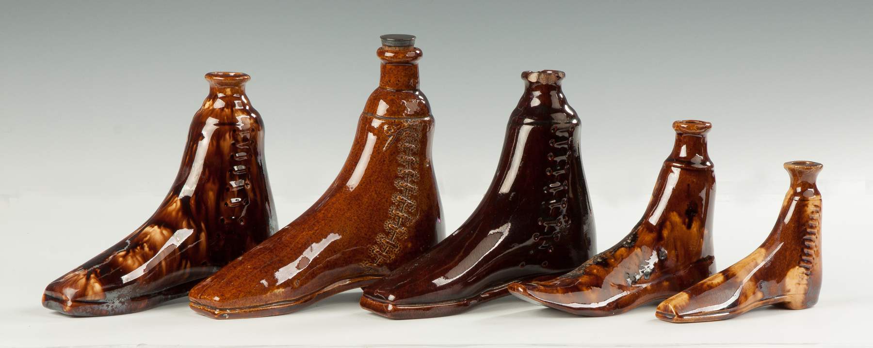 Collection of Rockingham Boot Flasks | Cottone Auctions