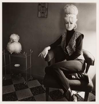 Diane Arbus (American, 1923-1971) "Lady Bartender at Home with a Souvenir Dog, New Orleans, LA., 1964"