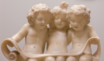 Alabaster Sculpture of Putti Holding Sheet Music