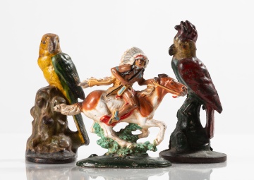 Three Painted Cast Iron Doorstops: Two Parrots and an Indian on Horseback