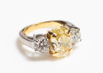 Platinum, High Karat Gold and Fancy Yellow Diamond Three-Stone Ring