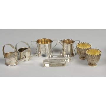 Various Sterling & silver pieces incl. Mini. Cartier watering cans, cream & sugar, napkin rings, etc.
